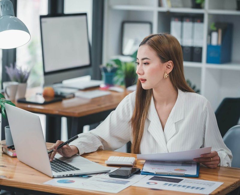 asian-woman-sitting-at-a-desk-working-in-the-office-use-a-computer-laptop-qldr89r0cn1vz95ehvieyhm7s4zh4kbnboep5k7fc4